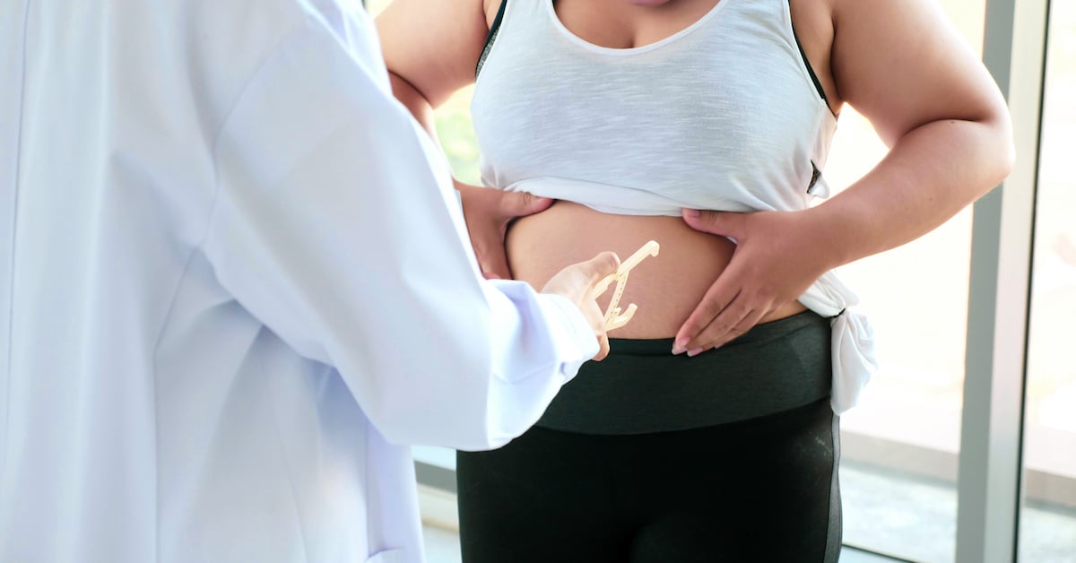 chubby-woman-touching-belly-hospital-room