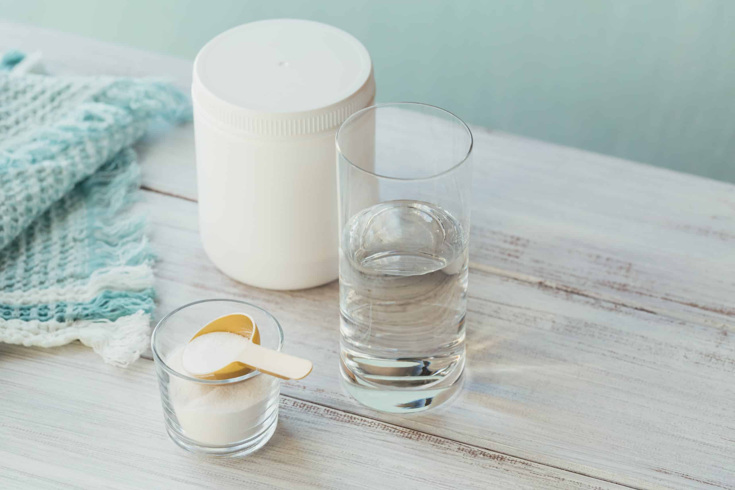 collagen-powder-bowl-glass-water-measure-spoon-light-blue-background-extra-protein-intake-natural-beauty-health-supplement-concept-scaled