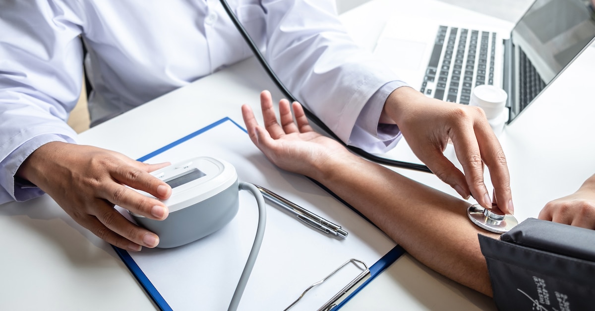 doctor-using-stethoscope-checking-measuring-arterial-blood-pressure-arm-patient-hospital