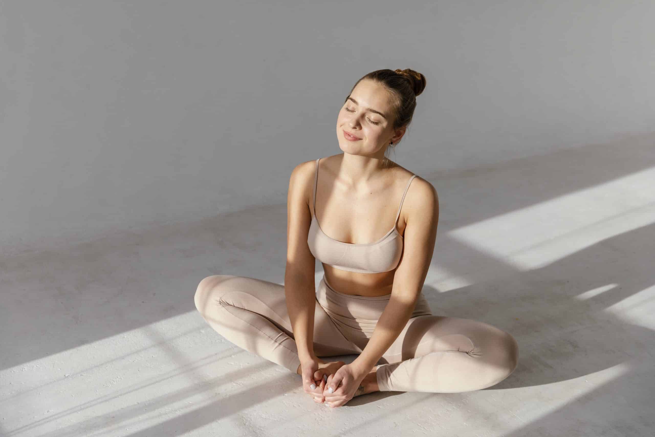 high-angle-woman-sitting-floor-scaled