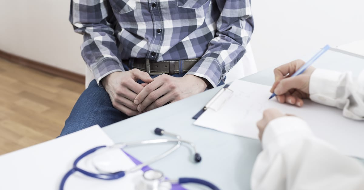 man-is-sitting-urologist-doctor-writes-prescription-medical-report