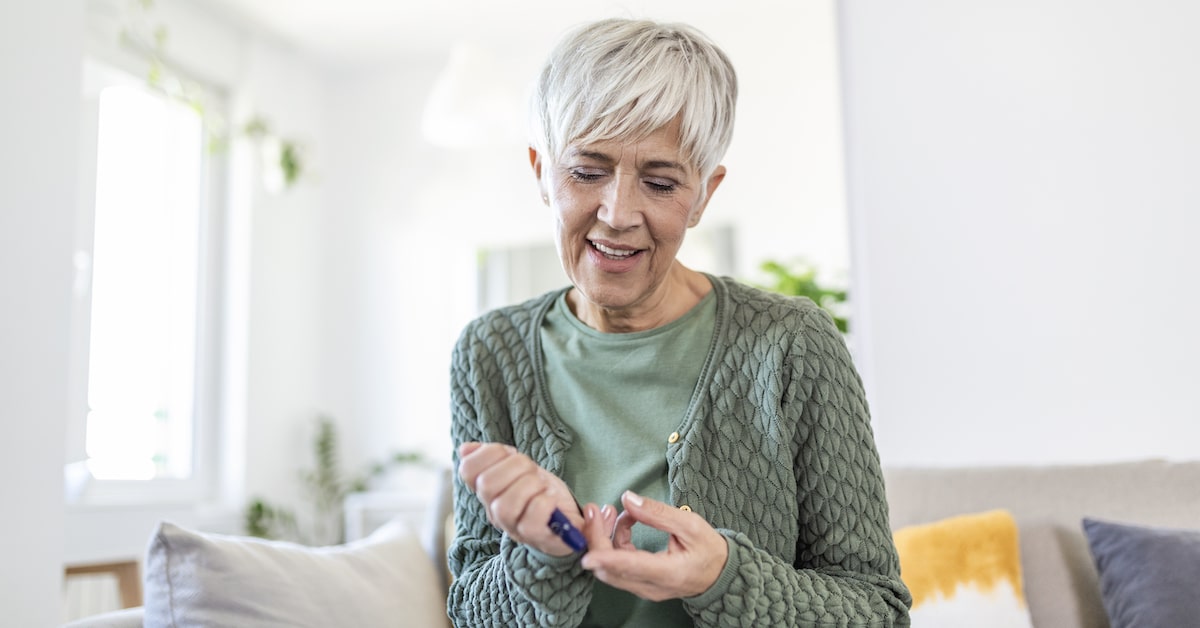 mature-woman-using-lancelet-finger-woman-doing-blood-sugar-test-home-living-room