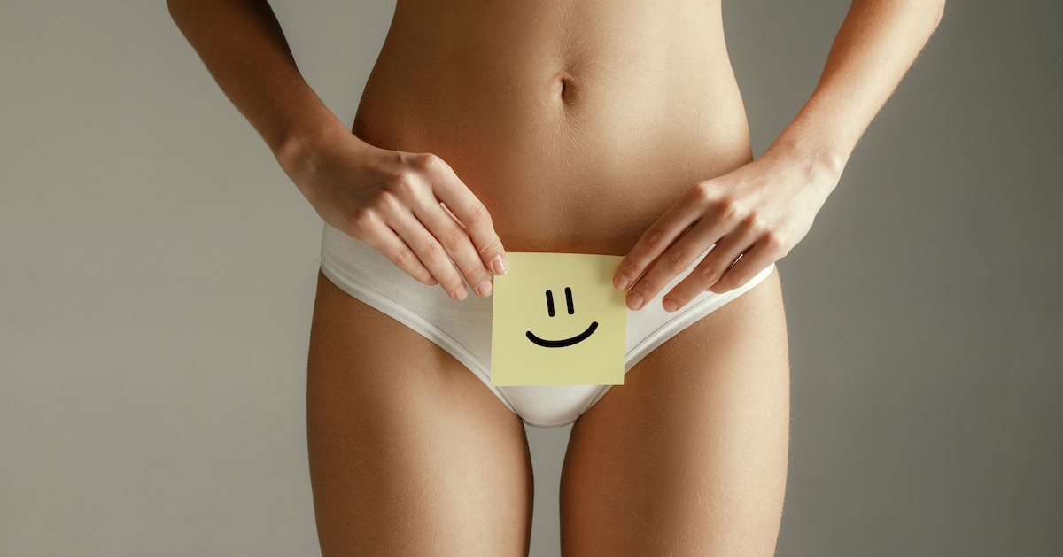 woman-health-female-model-holding-card-near-stomach-young-adult-girl-with-paper-sign-symbol-smile-isolated-gray-background
